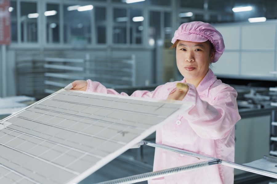 Female worker in solar panel assembly factory, Solar Valley, Dezhou, China